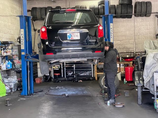 Sebastian Sanchez repairing a vehicle